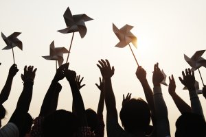 People holding pinwheels