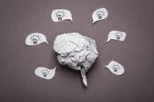 Medical background, Crumpled paper brain shape with light bulb
